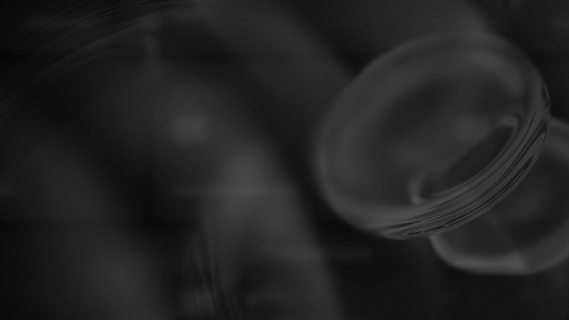 Abstract grayscale background with blurred circular shapes and gradients, creating a soft and mysterious atmosphere.