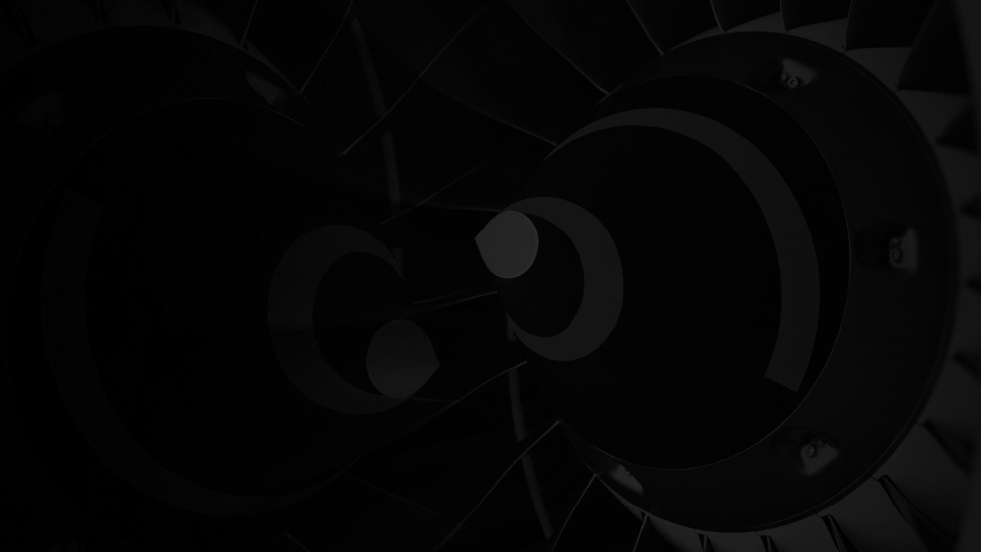 Close-up of a dark, abstract geometric pattern with circular shapes and radial lines, creating a sense of depth and symmetry.